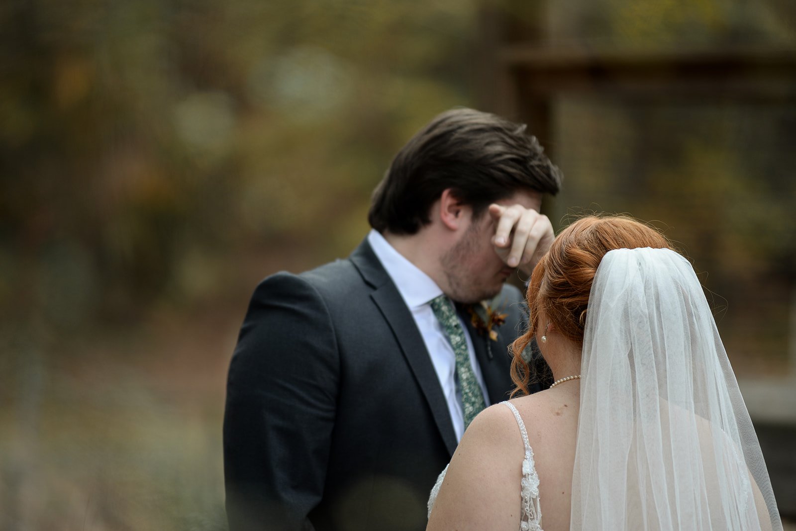 A North Georgia wedding first-look reaction in autumn forest