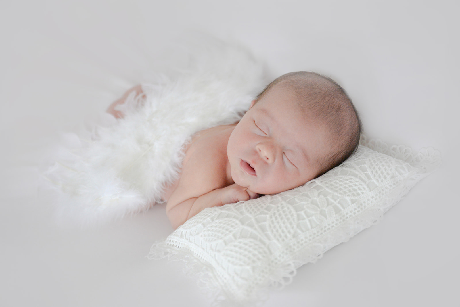 Newborn sleeping peacefully during natural light session in Roswell Georgia home lifestyle photography