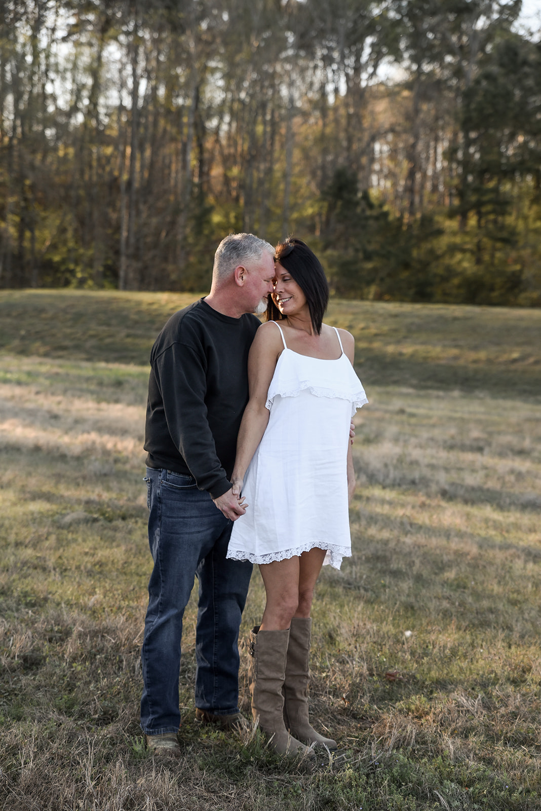 Engaged couple in open farm field near Loganville, GA Walton County at golden hour