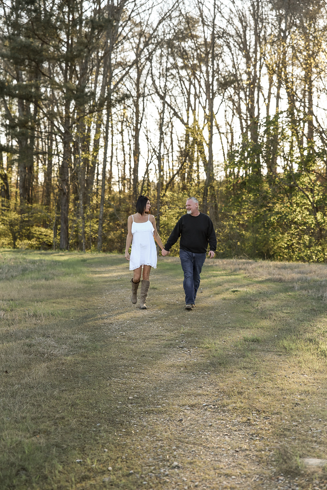 Couple holding hands during golden hour engagement session in Cherokee County Georgia