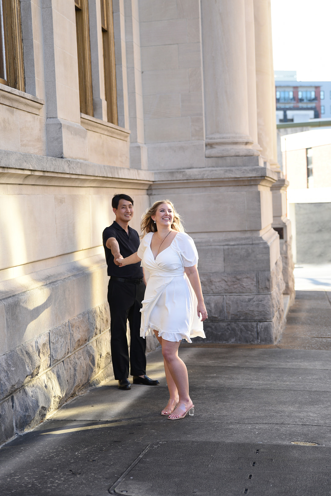 Engaged couple near historic Gwinnett County courthouse in Lawrenceville, GA