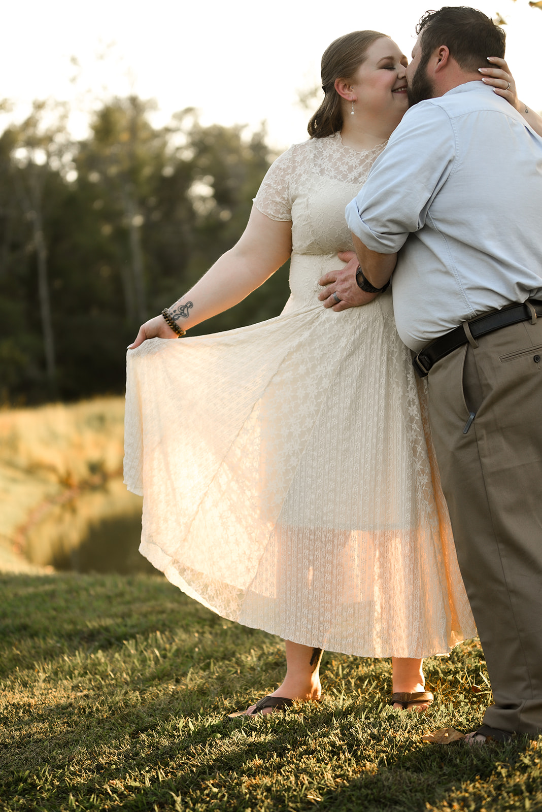 Engaged couple walking along Rogers Bridge Trail in Duluth, GA at golden hour