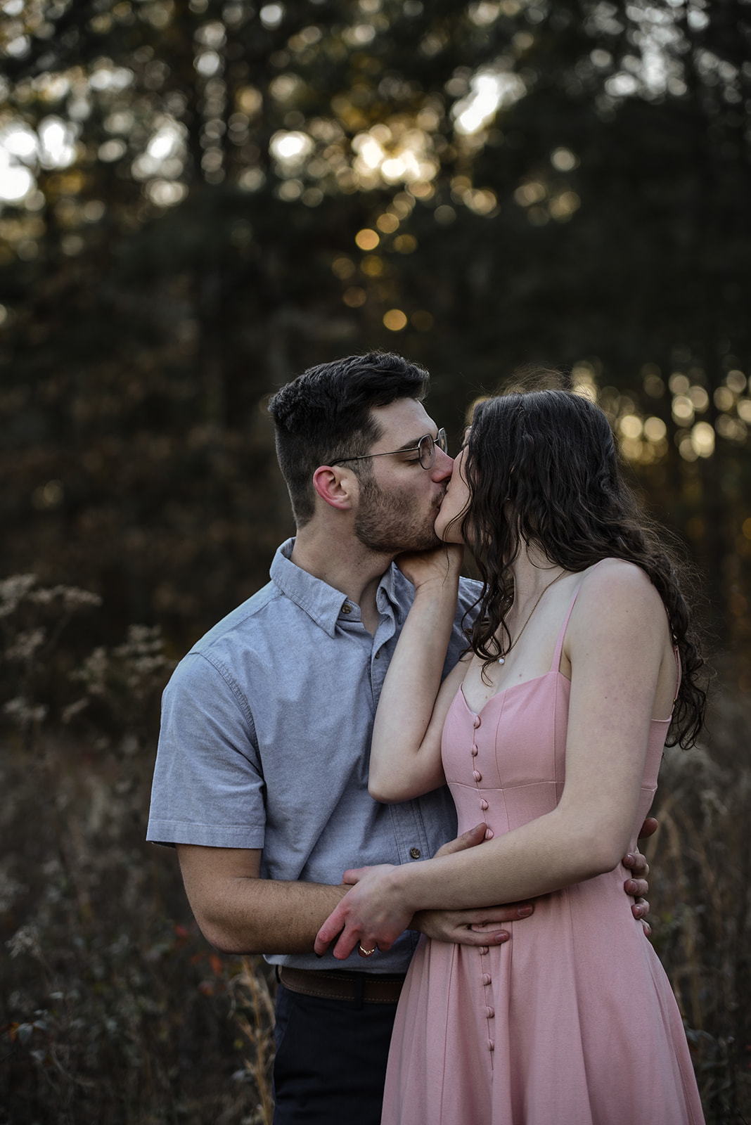 Couple standing at golden hour with Lake Burton visible in the distance, Rabun County Georgia