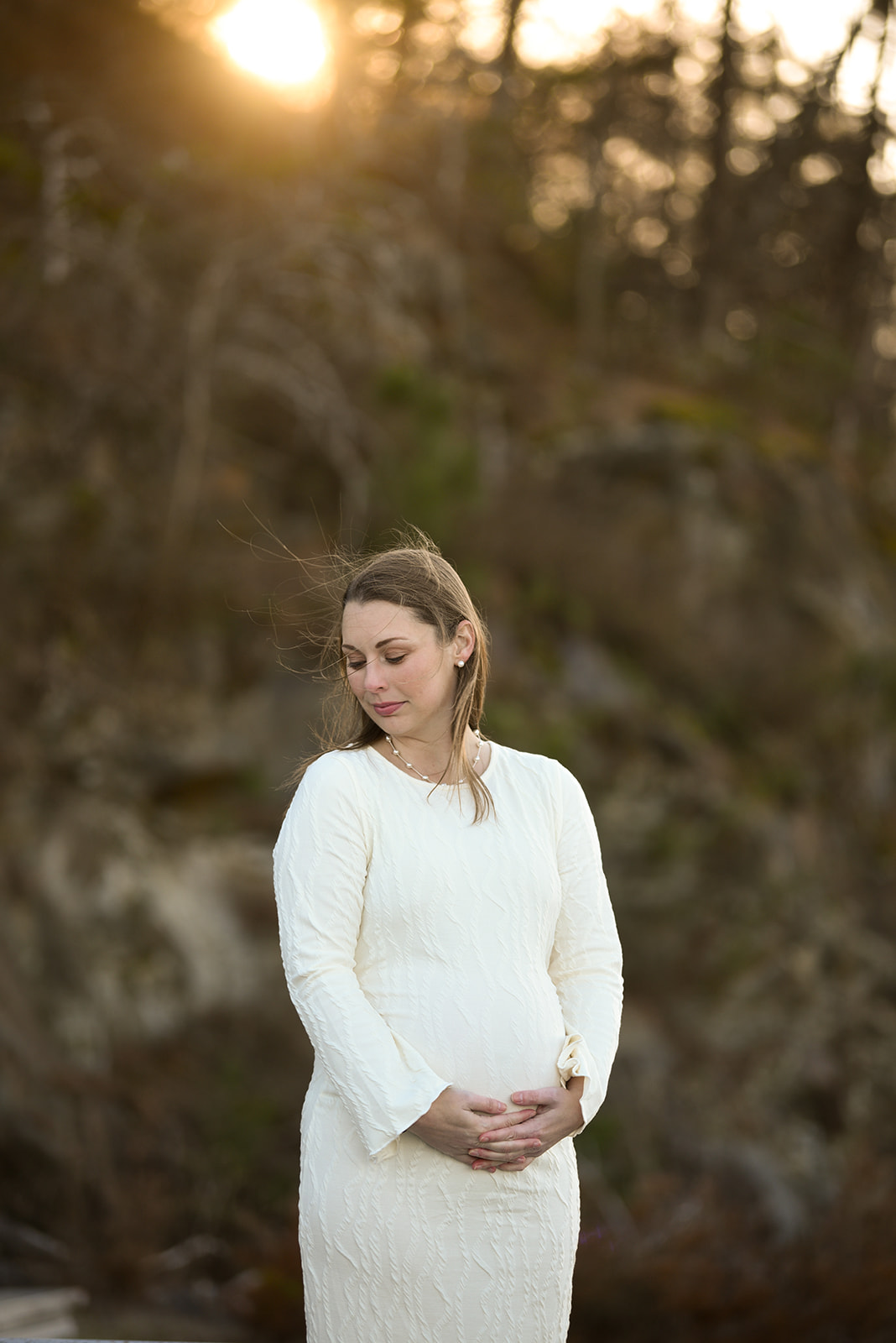 Expecting couple walking through apple orchard rows in Ellijay GA, maternity session fall light