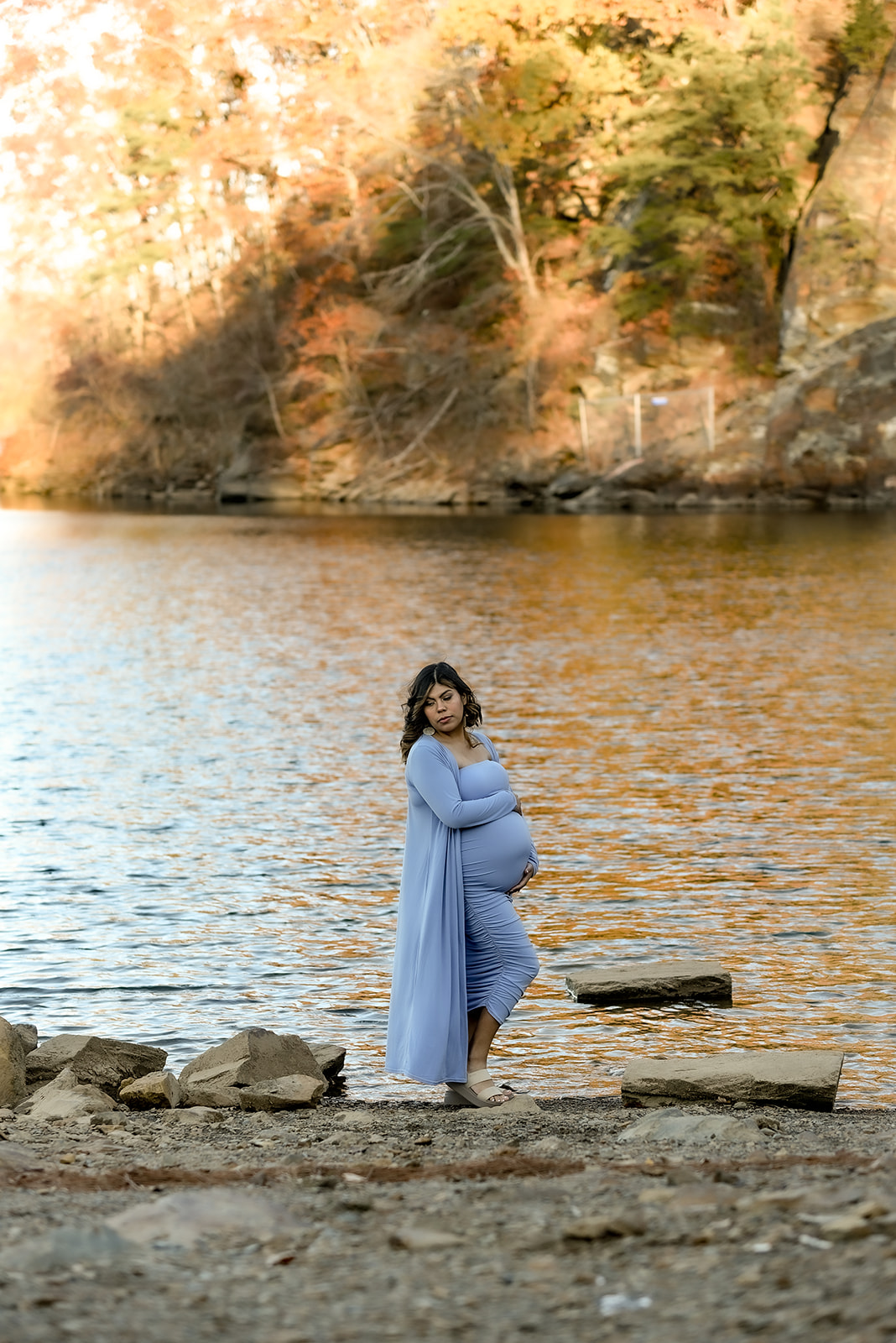 Close maternity portrait in North Georgia orchard setting, warm afternoon light through leaves