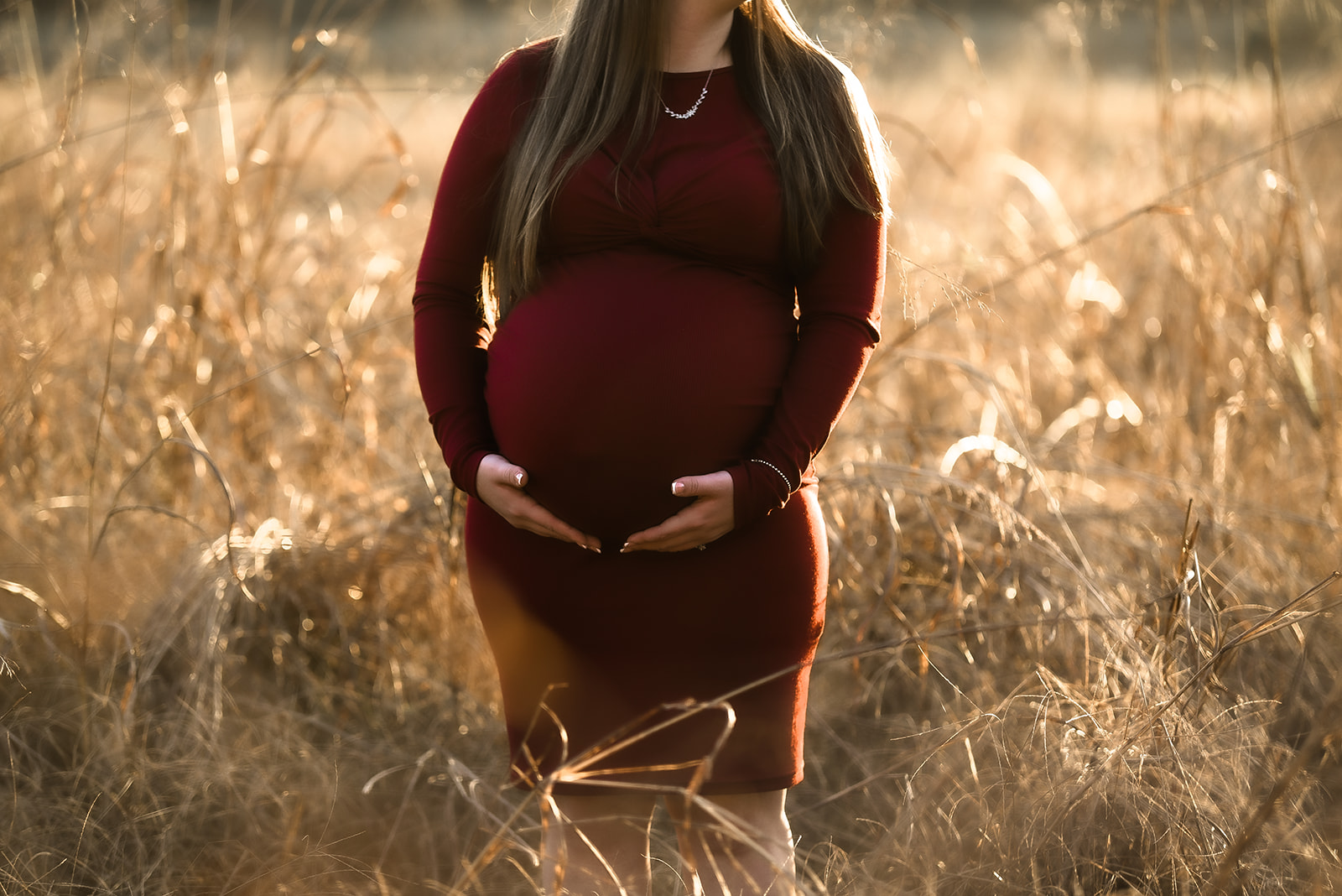 Couple during late pregnancy maternity session, looking toward distant Georgia ridge at golden hour