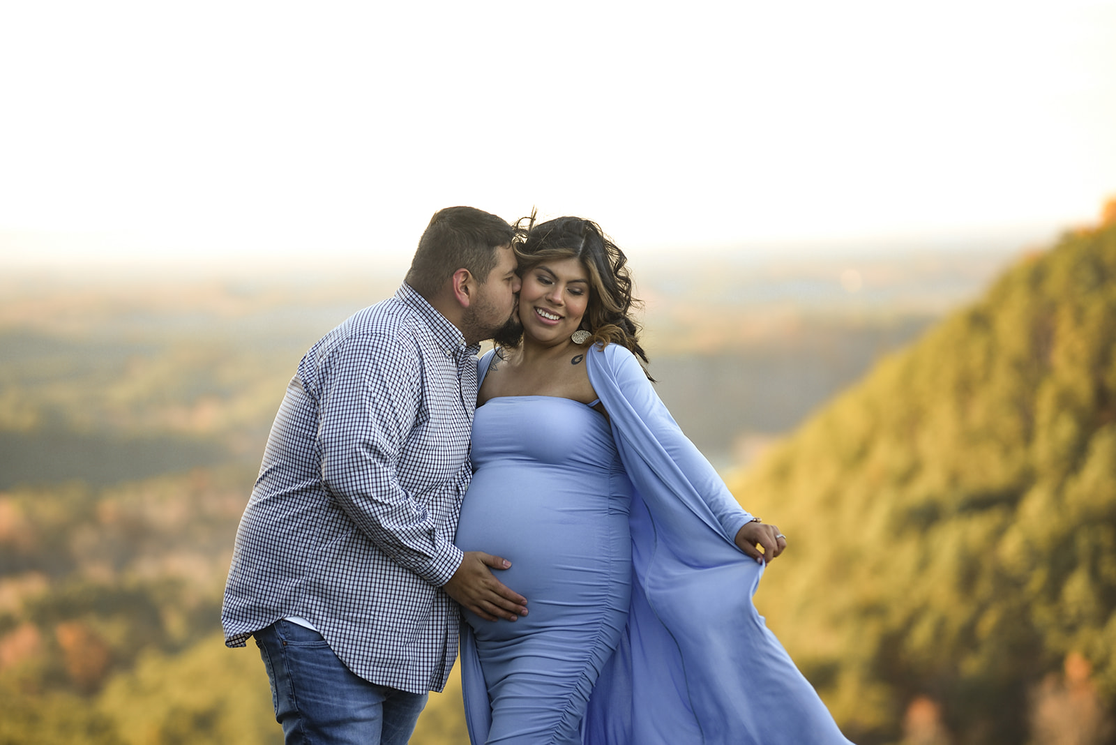 Maternity session in Cave Spring Georgia park, expectant mother standing near spring-fed water in soft light
