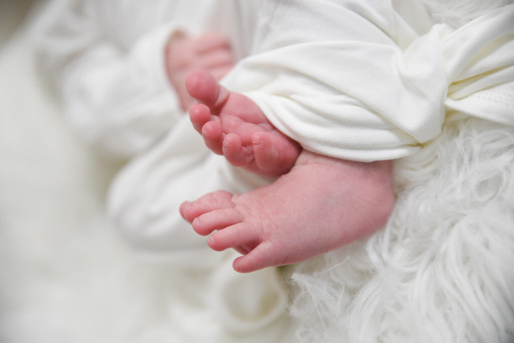 Newborn baby photographed in soft natural light during lifestyle session in Georgia