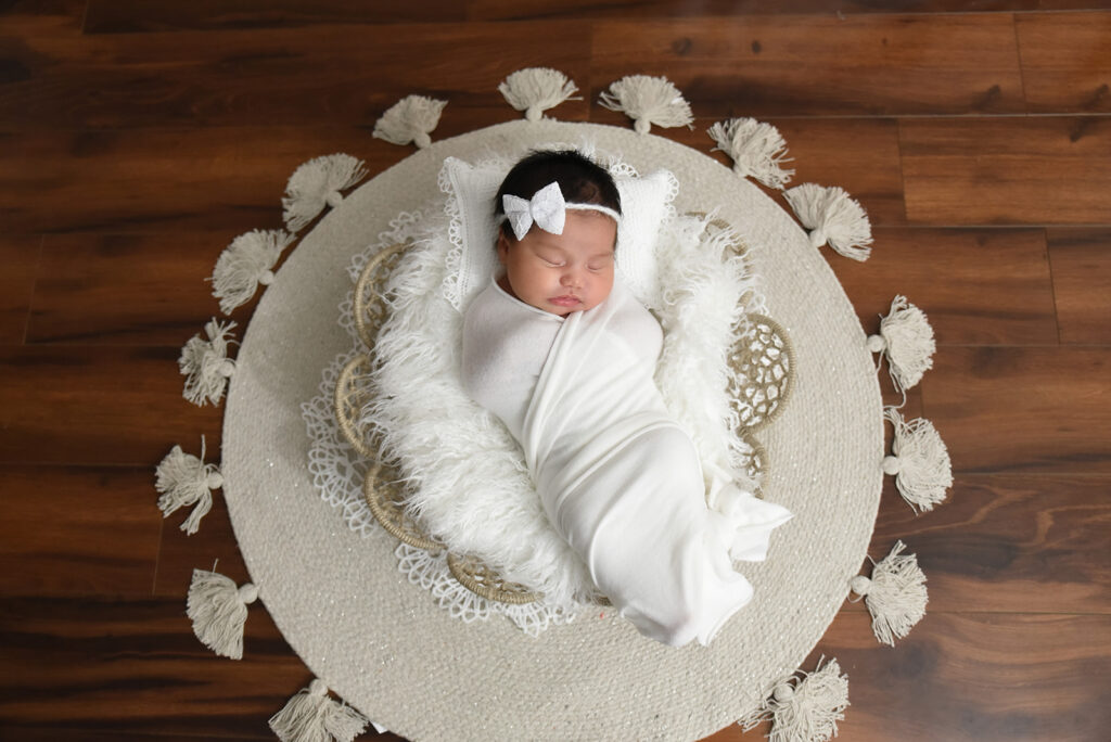 Newborn baby photographed in soft natural light during lifestyle session in Georgia