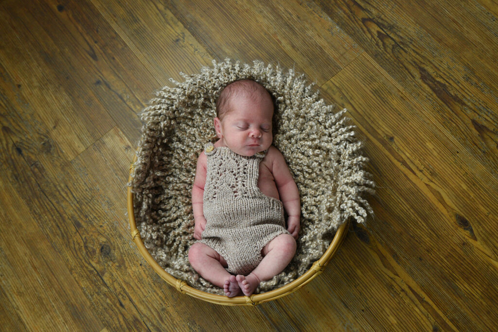 Newborn baby photographed in soft natural light during lifestyle session in Georgia
