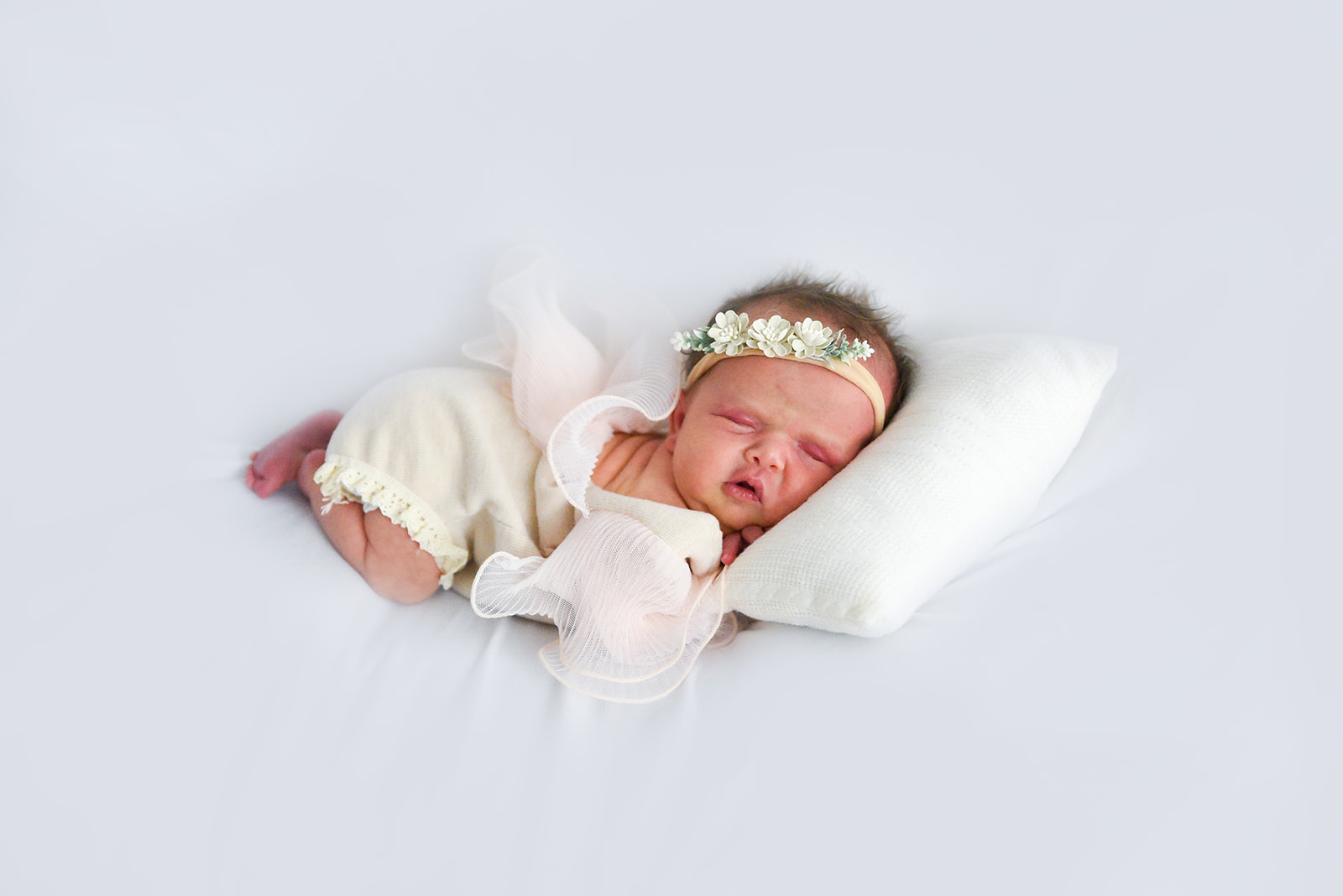 Sleeping newborn wrapped in soft neutral fabric photographed in Sugar Hill Gwinnett County Georgia home