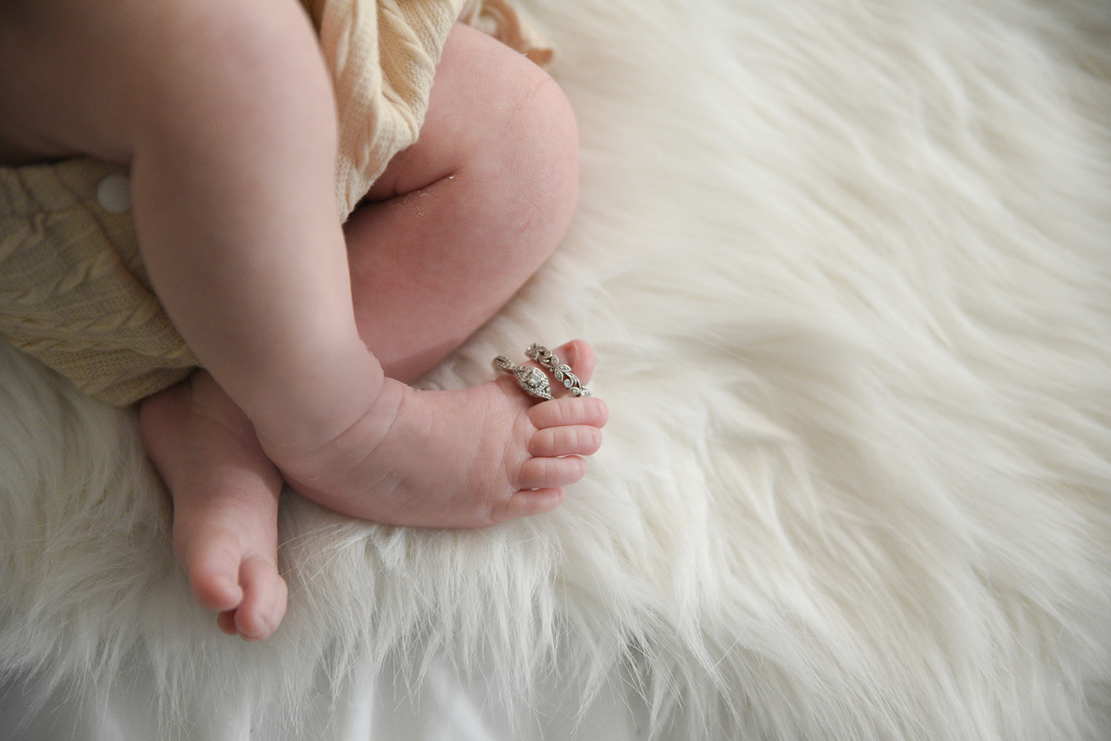 Father holding sleeping newborn during lifestyle photography session in Sugar Hill GA home