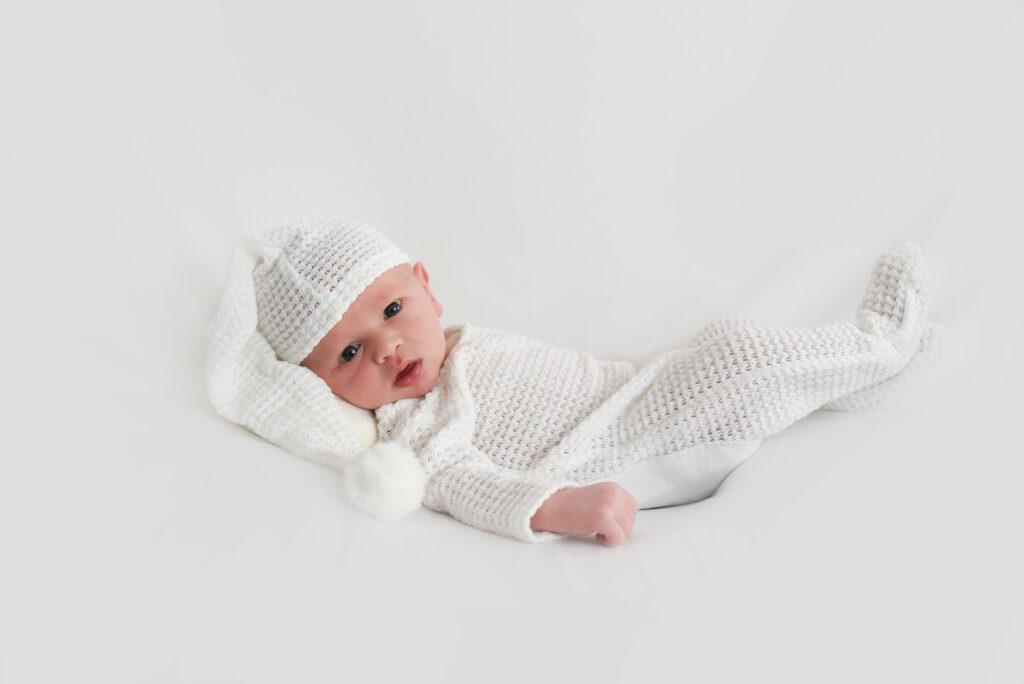 Newborn baby photographed in soft natural light during lifestyle session in Georgia