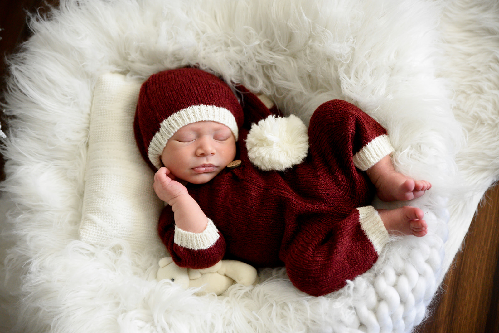 Newborn baby posed in soft wrap photographed in Roswell GA home with warm natural light