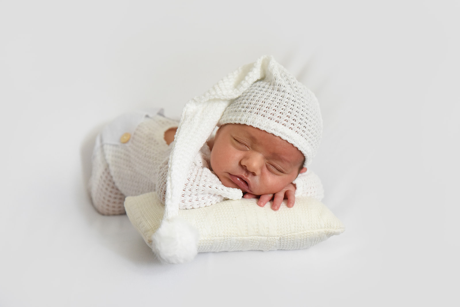 Mother holding newborn close in natural morning light during Roswell Georgia in-home photography session